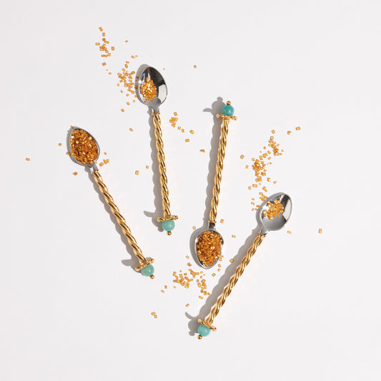 L’Objet Venise 24k gold-plated dessert spoons with amazonite stones arranged with colorful garnishes